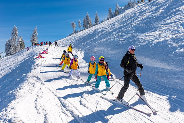 Ski school confidential instructor with kids