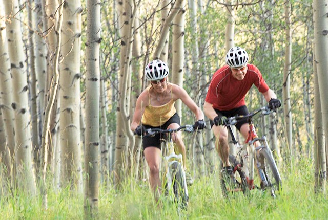 Crested Butte, CO, mountain biking couple, female gold medal Olympian, biking through aspens.