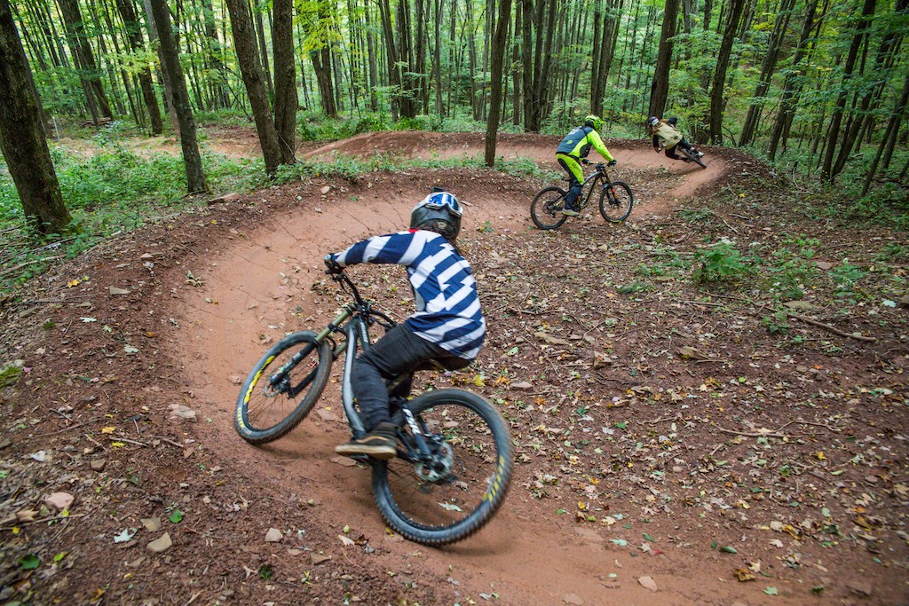 Group of riders biking through the woods at Snowshoe