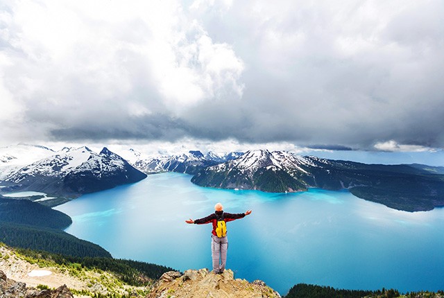 Whister Blackcomb Resort. Canada, hiker overlooking lakes and mountains view, summer.