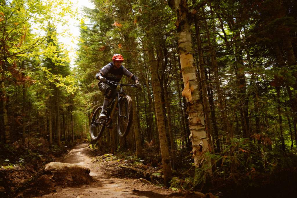 Mountain biker catching air at Mont Sainte Anne.