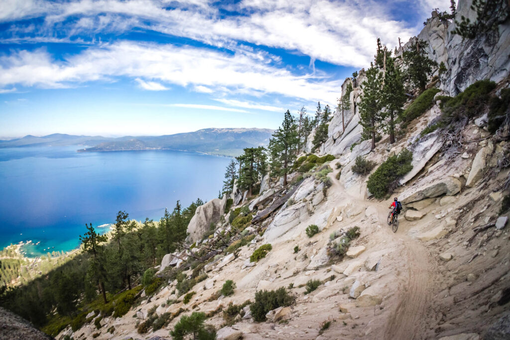 Mountain biker riding above Lake Tahoe on a sunny day